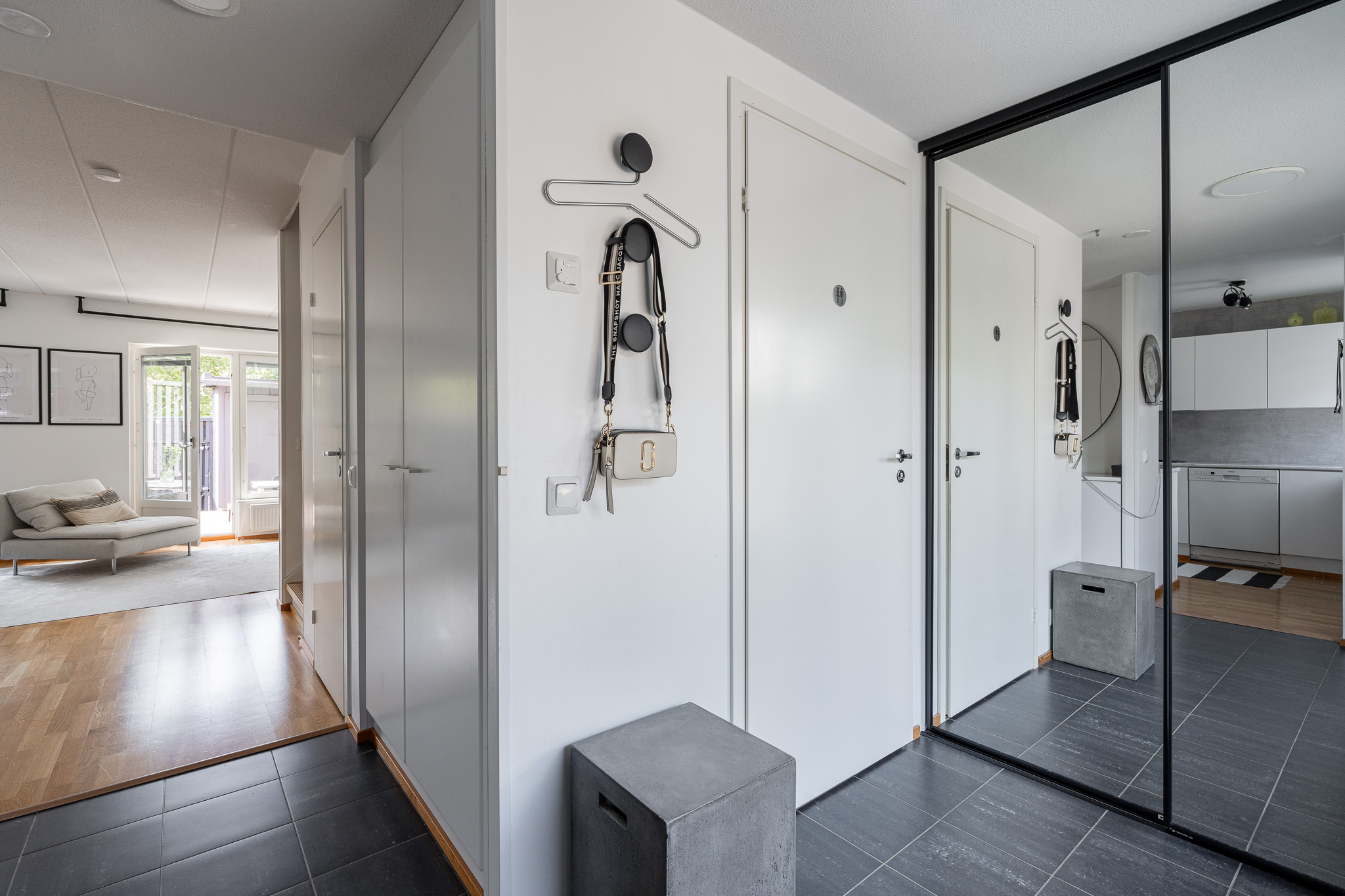 Entrance hall with a sliding mirror wardrobe and dark tiled floor