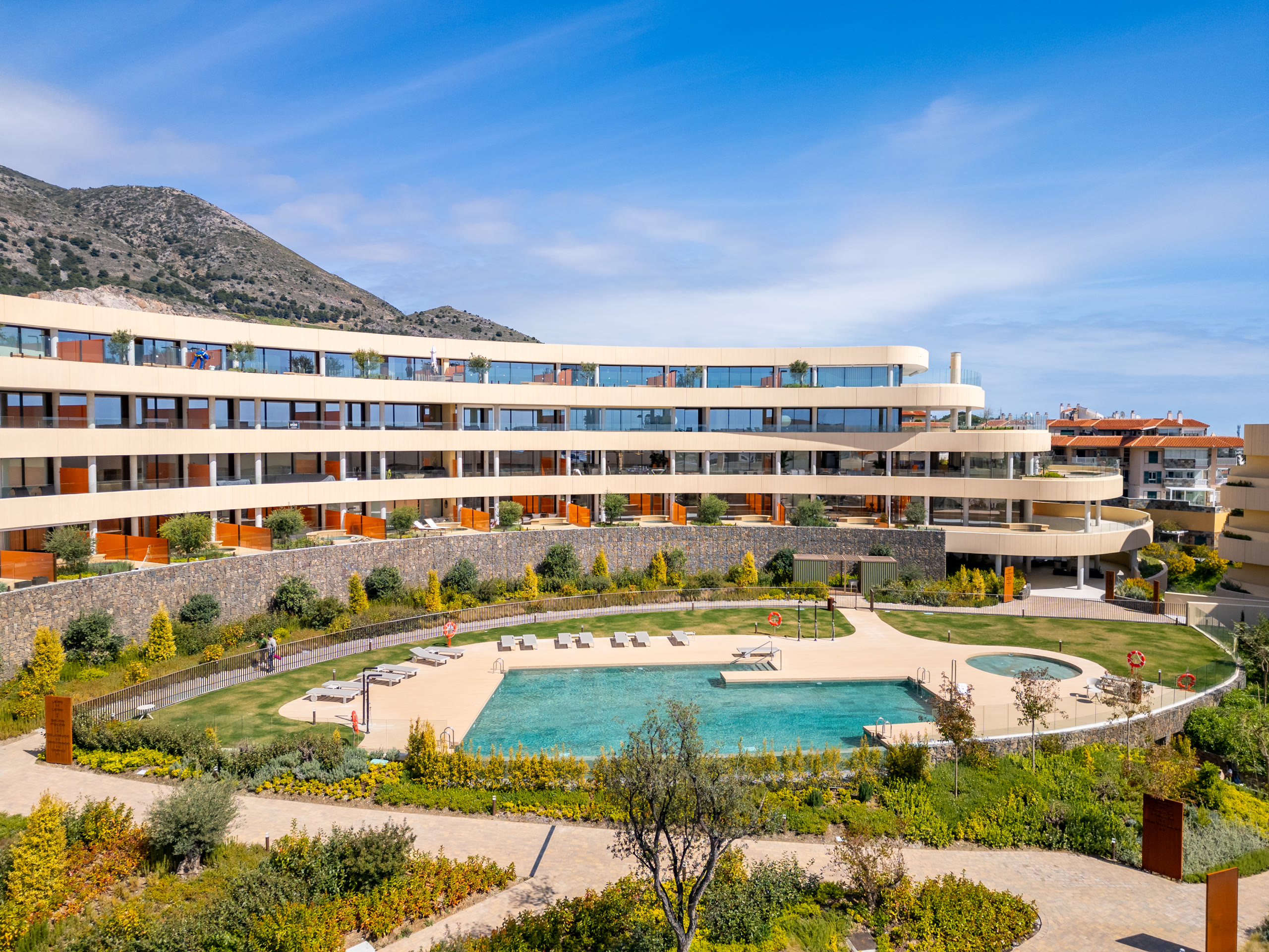 Aerial view of South Residences with its pool and terraced gardens in El Higuerón